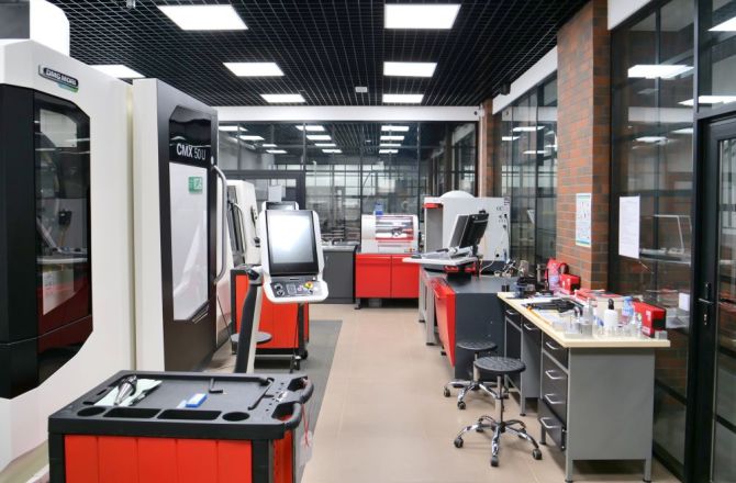 Nowoczesne laboratorium CNC wyposażone w frezarki i tokarki sterowane numerycznie, wykorzystywane do kształcenia studentów w zakresie technologii obróbki metali